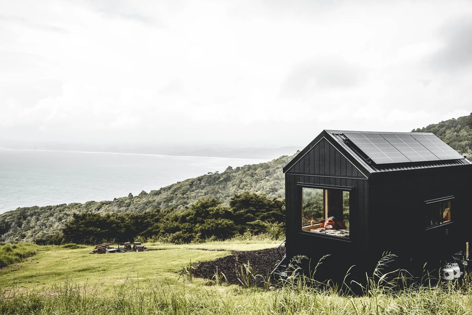 Black cabin above the coast